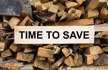 Wall firewood. Background of dry chopped firewood logs in a pile and plate with text Time To Save