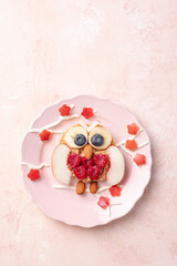 Owl pancakes with fruits for kids breakfast. Spring and flowers