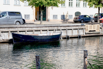 Fototapeta na wymiar Copenhagen, Denmark-Christianshavn canal, colorful facades of old houses. King Christian's Harbour is a neighbourhood in Copenhagen. Real estate investment. Rent an apartment. Expensive housing. 
