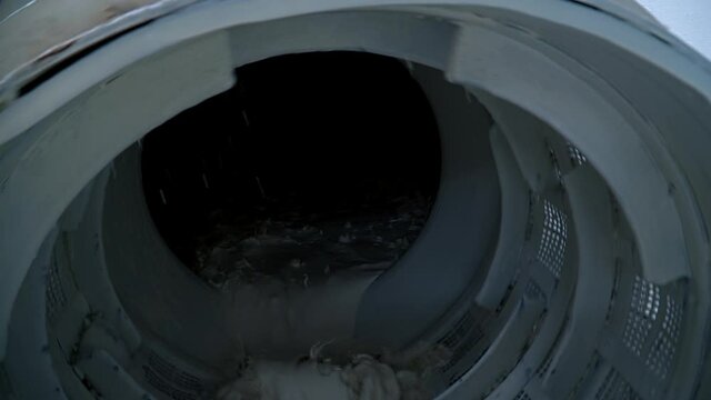 White kaolin clay mixed up with water being filtered at the factory. Up-to-date kaolin industry manufacturing.