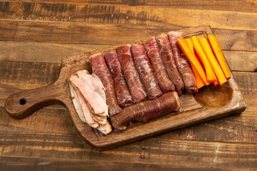 beef roll raw to prepare with bacon and carrots