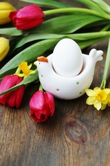 Easter background, egg, egg stand, chicken figurine, spring flowers, tulips, daffodils