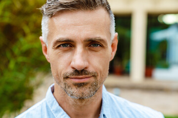 White mature man with bristle posing and looking at camera