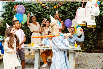 White girl breaking toy unicorn during birthday party