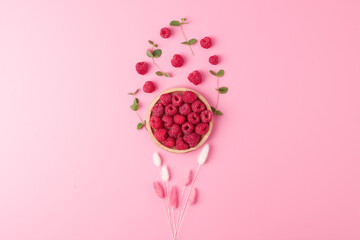 Creative summer background made from fresh berries and flowers on pink. Flat lay, copy space. © luckyshoe