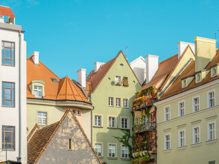 Old colorful facades of houses with cozy balconies wicked with ivy in medieval european city. Cozy pastel color houses with tiled roofs in Wroclaw, Poland