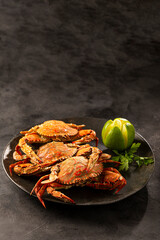 Dish of cooked crabs on the table.