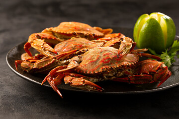 Dish of cooked crabs on the table.