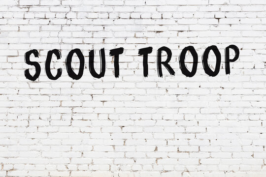 White Wall With Black Paint Inscription Scout Troop On It