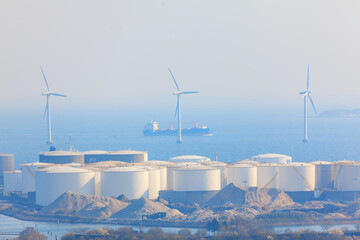 Petroleum Storage in Copenhagen . Coastal tanks with oil . Windmill farm in the North Sea