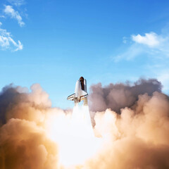 Successful start of a space mission, concept. Shuttle rocket with clouds of smoke takes off into the blue sky
