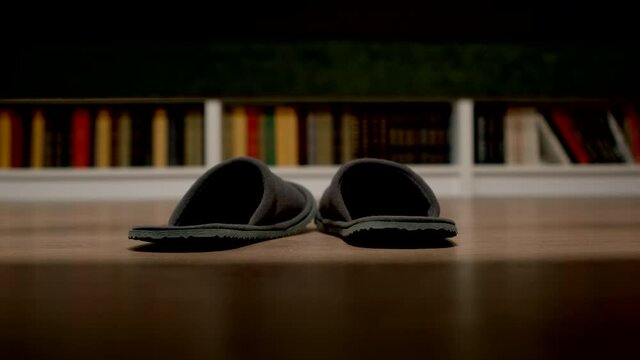 Night light turns on and the man's feet put on slippers and go to the toilet - Close Up