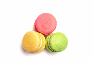 Banner of colorful macaroons isolated on white background. Lemon yellow, strawberry pink and green french cookies. Caramel hazelnut and strawberry cakes in front view. Bakery concept with blank space