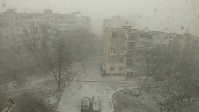 Snow storm in the yard in winter - Shooting through the window