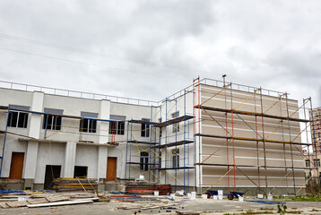 The progress of construction of the kindergarten building. Modern decoration of building facades