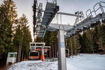 Fototapeta premium Ski resort image with empty chair lift. Ski-lift