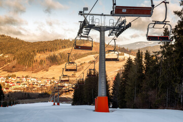 Winter ski resort image with empty chair lift. Ski-lift