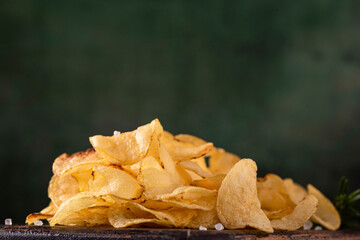 fried potato chips with sea salt, on a wooden board
