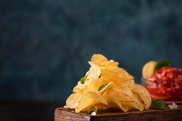 stack of fried potato chips with herbs and tomato sauce
