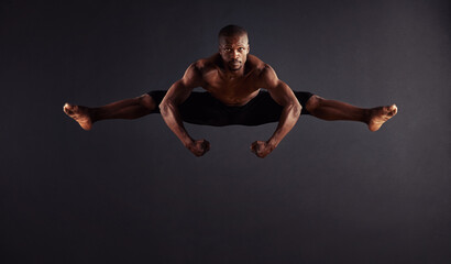 Perfection attained. Male dancer performing the splits in mid-air.