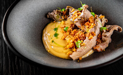 Mashed potatoes with fried oyster mushrooms in bowl