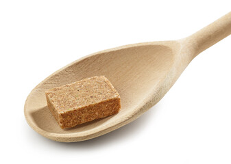 instant beef broth cube in wooden spoon