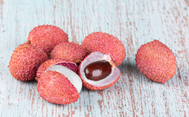 Lychee fruits isolated on a light wooden background