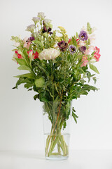 Beautiful bouquet of flowers in a vase. Bouquet of chrysanthemum, alstroemeria, goldenrod, snapdragon, lisianthus and eucalyptus parvifolia. bouquet of flowers on white background. 