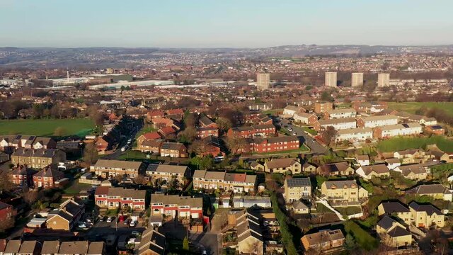 Aerial footage of the town of Pudsey in Leeds in the UK showing a typical British housing estate in the winter time on a cold day
