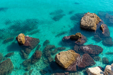 Detail of the sea and rocks on Calahonda beach in the town of Nerja, Andalucia. Spain. Costa del sol in the Mediterranean Sea.