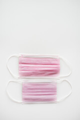 Children's and adult medical face mask in pink color on a white background. isolate. protective devices in medicine. protection against covid-19