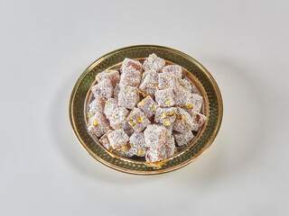 Turkish delight is in the plate, white isolated background.