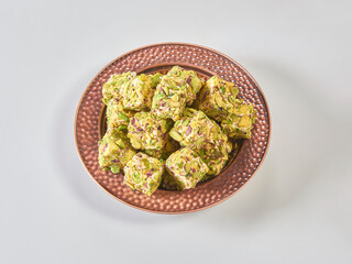 Turkish delight is in the plate, white isolated background.