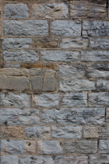 Fragment of old stone wall with cracks