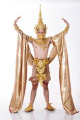 Full length portrait of 20s asian man wear gold leaf foil and golden dress of National costume