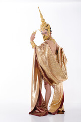 Full length portrait of 20s asian man wear gold leaf foil and golden dress of National costume