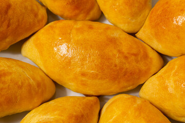 Traditional turkish breakfast savory pastry food close-up top view. It is known as Poaca or Poğaça in Turkish. It is a very popular breakfast food. Cheese, olives, sausage can be put inside.