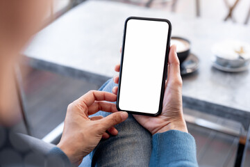 cell phone blank white screen mockup.hand holding texting using mobile on desk at office.background empty space for advertise.work people contact marketing business,technology