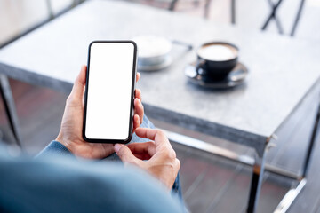 cell phone blank white screen mockup.hand holding texting using mobile on desk at office.background empty space for advertise.work people contact marketing business,technology