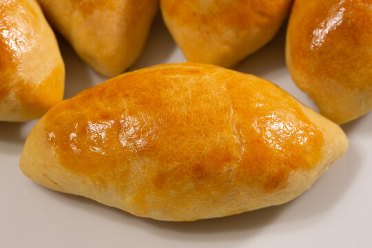 Traditional turkish breakfast savory pastry food close-up top view. It is known as Poaca or Poğa&ccedil;a in Turkish. It is a very popular breakfast food. Cheese, olives, sausage can be put inside.