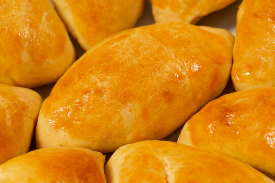 Traditional turkish breakfast savory pastry food close-up top view. It is known as Poaca or Poğa&ccedil;a in Turkish. It is a very popular breakfast food. Cheese, olives, sausage can be put inside.