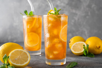 Ice tea or long island cocktail with slice of lemon on a dark background. copy space, selective focus