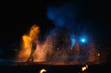 Fire show, dancing with flame, male master juggling with fireworks, performance outdoors, draws a...