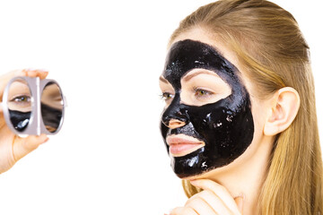 Woman with black peel off mask on face