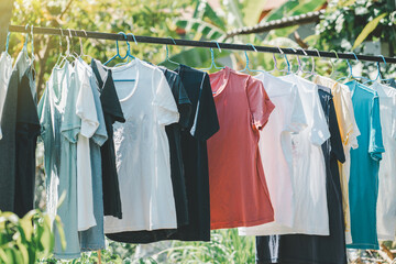 Washing day with T-shirts hanging on clothesline.