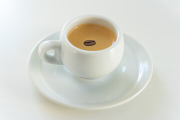 a small coffee in a white cup