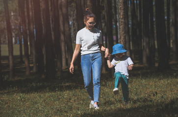 Asian mother and son in nature garden.