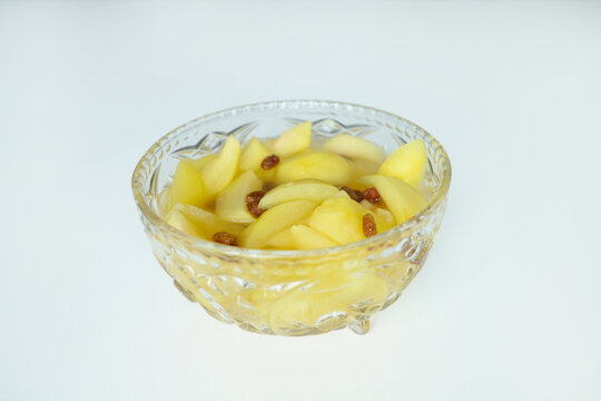 Stewed apples with raisins in an old glass bowl