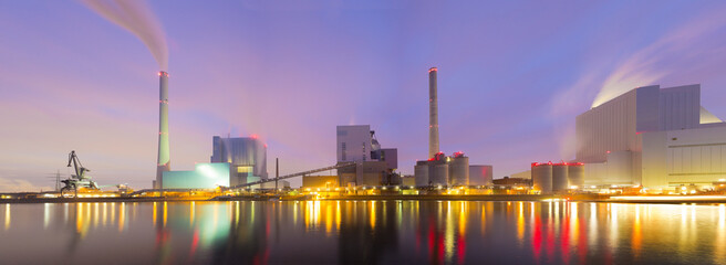 Panorama of illuminated coal power plant early in the morning