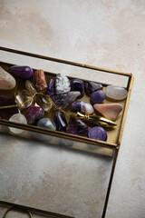 Pendulum and colorful gemstones in a glass box
